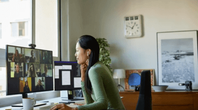 Woman sitting looking at screen at desk 